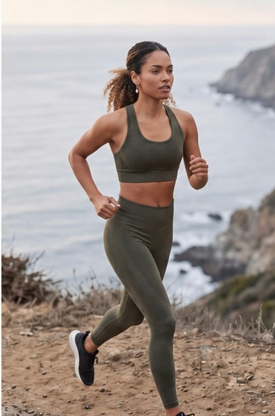 Woman running on a trail with ocean and cliffs in the background wearing Pola Earrings from Delani Jewelry