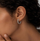 Dhana Hoops by Delani Jewelry in polished silver stainless steel, waterproof, tarnish-proof twisted hoop earrings with a Lifetime Color Guarantee.