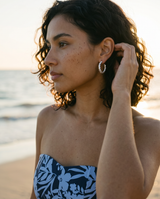 Dhana Hoops by Delani Jewelry in polished silver stainless steel, waterproof, tarnish-proof twisted hoop earrings with a Lifetime Color Guarantee.