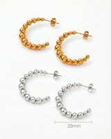 Gold and Silver Kendall Hoops by Delani Jewelry featuring sleek, modern jewelry design with polished finish. Product sizing of 20mm included in photo. 
