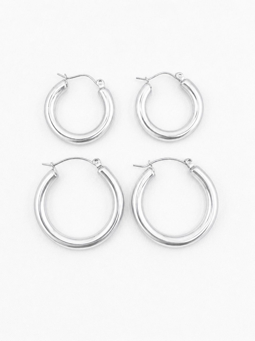 Set of four silver Holly Hoop earrings on a white background for Delani Jewelry