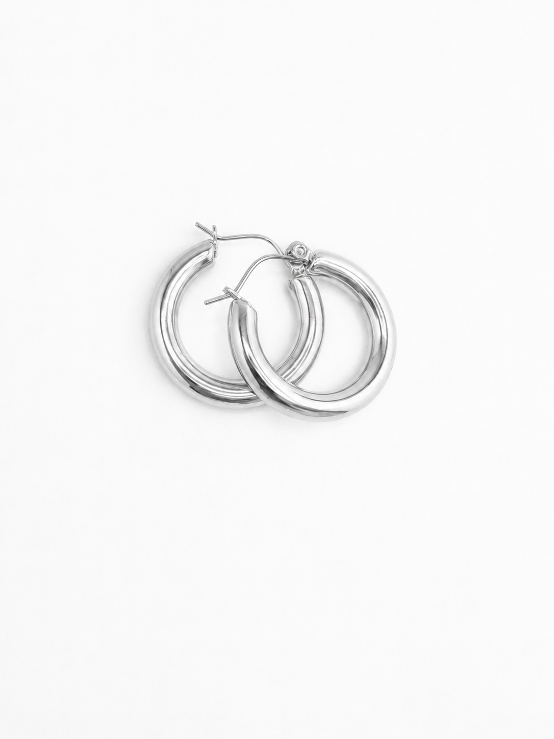 Pair of silver Holly hoop earrings on a white background from Delani Jewelry