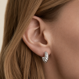 Delani Jewelry Kala Hoop Earrings in waterproof, tarnish-proof silver PVD stainless steel with a lifetime color guarantee, featuring a chunky twisted hoop design.