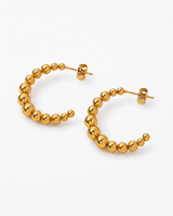 Gold Kendall Hoops by Delani Jewelry featuring sleek, modern jewelry design with polished finish.