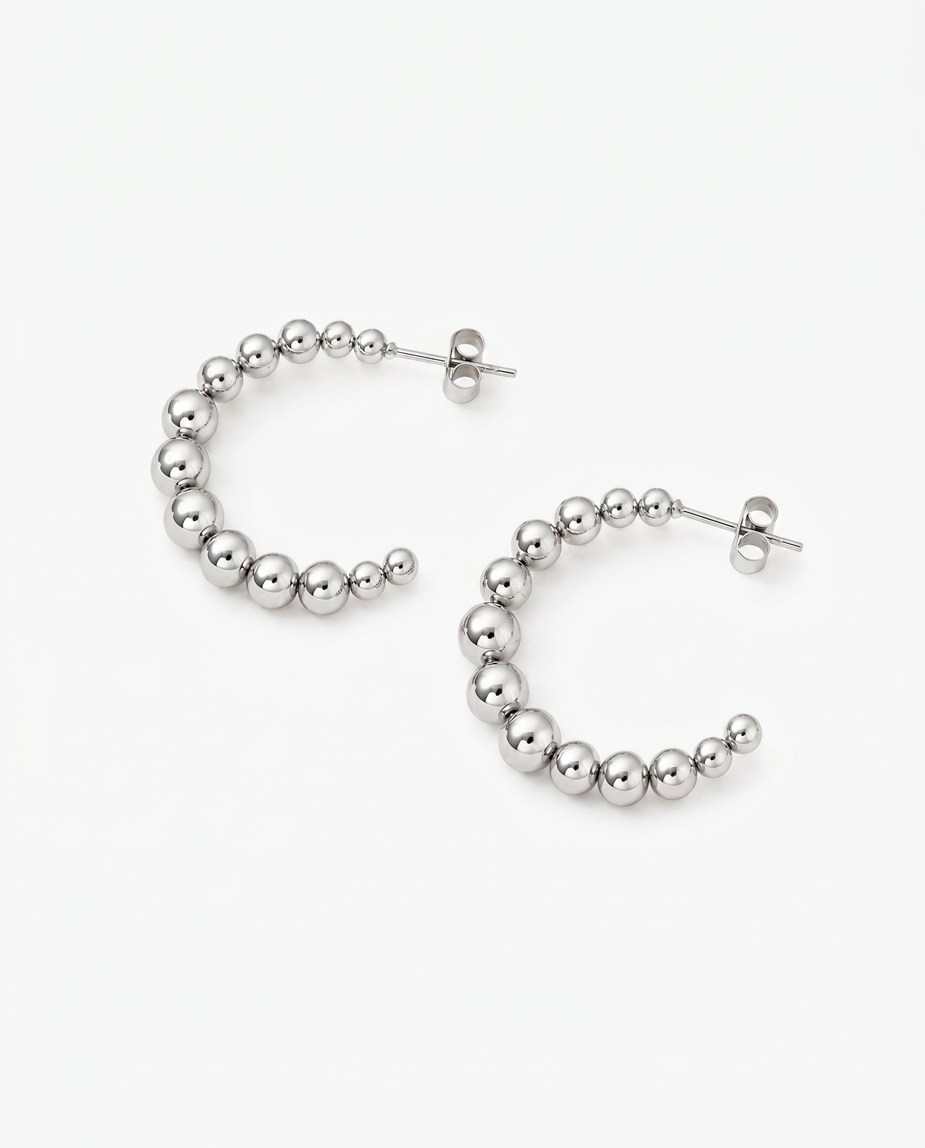 Silver Kendall Hoops by Delani Jewelry featuring sleek, modern jewelry design with polished finish.
