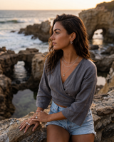 A woman with long brown hair in silver Myra earrings from Delani Jewelry.  