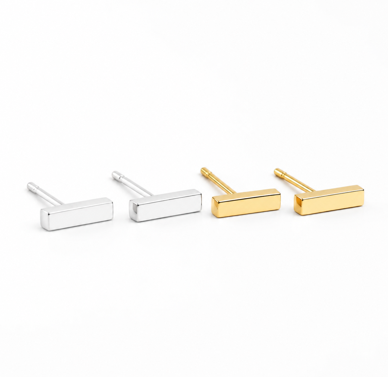 Gold and silver bar stud earrings from Delani Jewelry featuring sleek geometric rectangular studs with a polished finish, perfect for first, second, and third lobe piercings. Named Namaari Studs