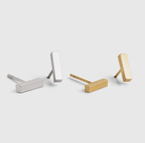 Delani Jewelry minimalist bar stud earrings in gold and silver, polished rectangular earrings displayed side by side for modern everyday jewelry styling. Named Namaari Studs