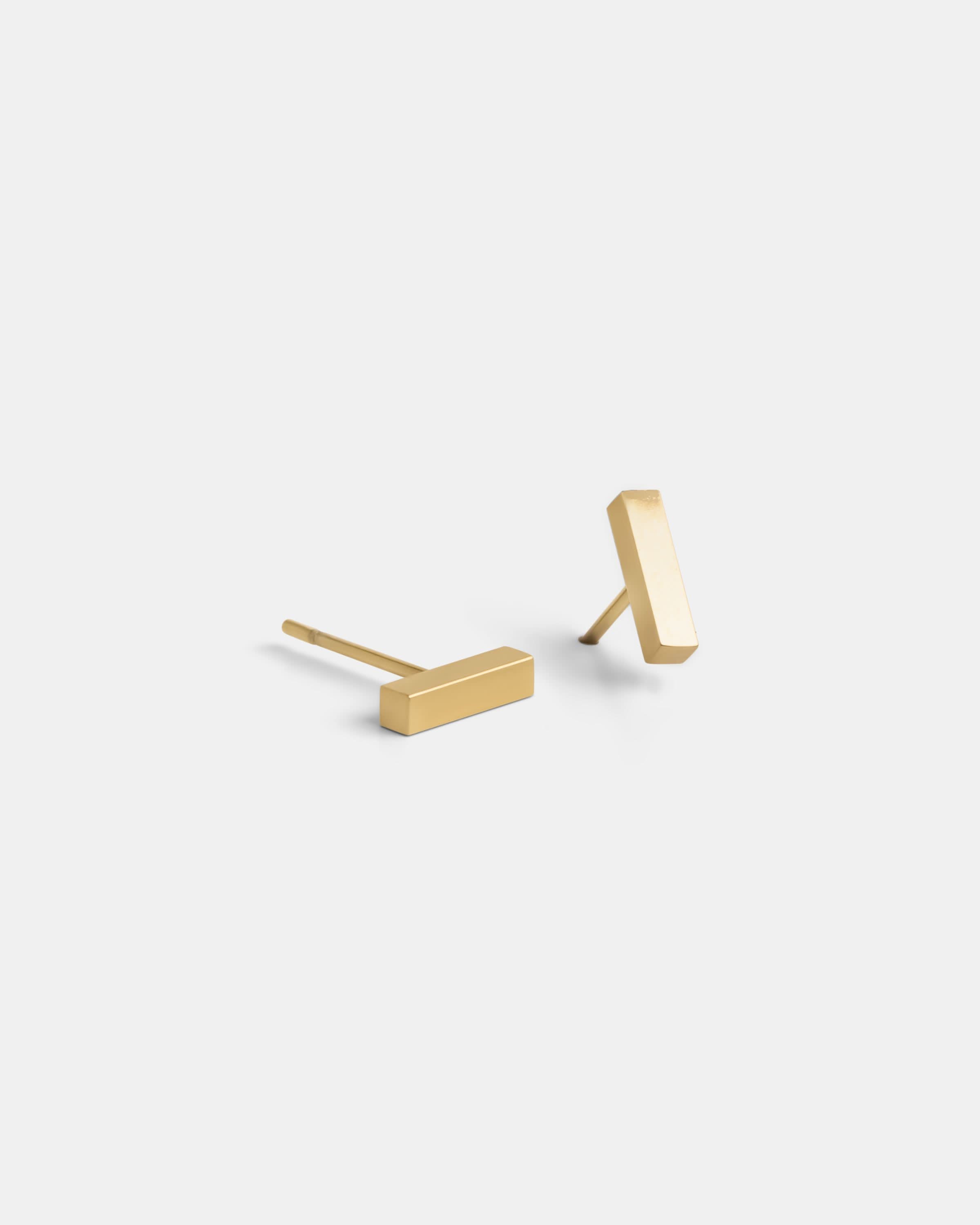 Delani Jewelry gold bar stud earrings with a sleek minimalist design, polished 14K gold finish, lightweight everyday earrings for modern style. Named Namaari Studs