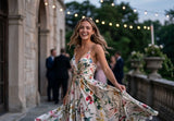 Lifestyle photo of a model wearing Delani Jewelry Nubia Long Pearl Earrings with a floral dress for an elegant occasion. Tarnish-free, waterproof earrings with a lifetime color guarantee.