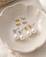 Delani Jewelry's Oma Earrings in a dish displaying both colors of metal, silver and gold. Earrings are waterproof, tarnish-proof and have a lifetime color guarantee. 