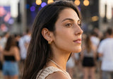 Lifestyle portrait of a model wearing Delani Jewelry Saja Hoop Earrings in gold. Waterproof, tarnish-proof triple hoops with a lifetime color guarantee for elevated everyday style.