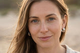 Beach lifestyle portrait featuring Delani Jewelry Saja Hoop Earrings in silver. Waterproof, tarnish-proof triple hoops with a lifetime color guarantee, perfect for everyday and vacation wear.