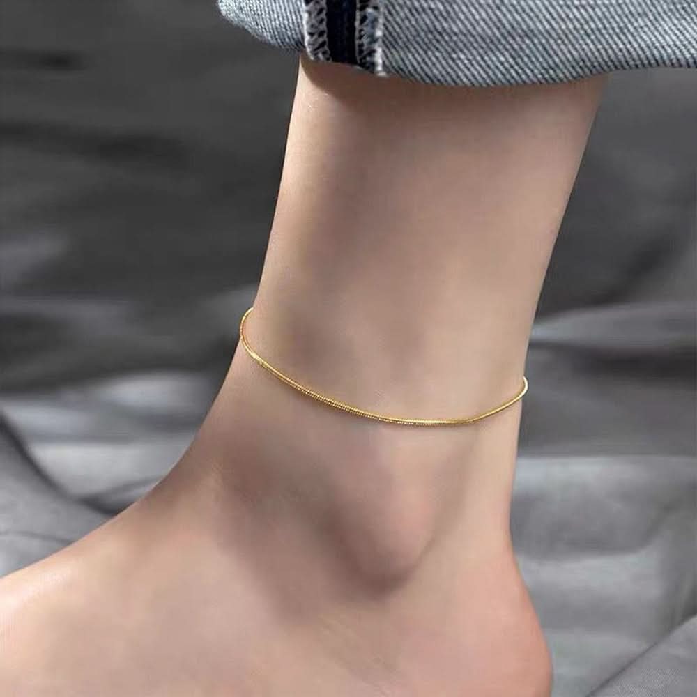 Silver Lyra anklet from Delani Jewelry featuring delicate chain and small charm accents.
