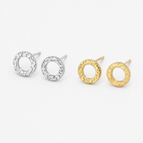 Three textured circular stud earrings on a light gray background, including two silver-toned and one gold-toned pair. Hammered Circle Studs – Waterproof, Tarnish-Proof Beach-Ready Earrings from delani jewelry