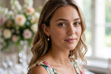 Elegant portrait featuring Delani Jewelry Nubia Short Pearl Earrings with luminous freshwater pearls. Tarnish-free, waterproof earrings with a lifetime color guarantee, perfect for weddings, brunches, and everyday wear.